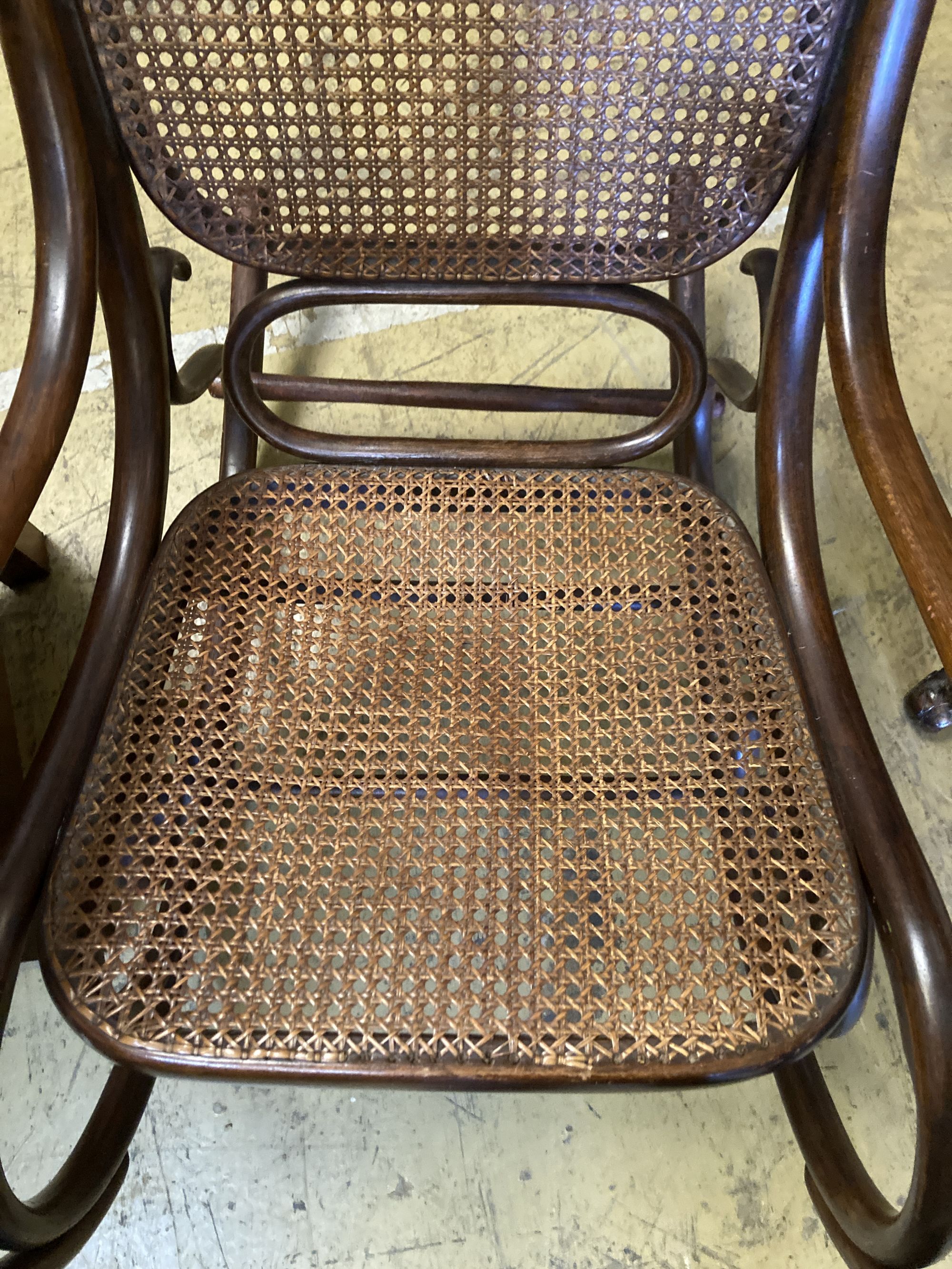 An early 20th century Thonet style caned bentwood rocking chair